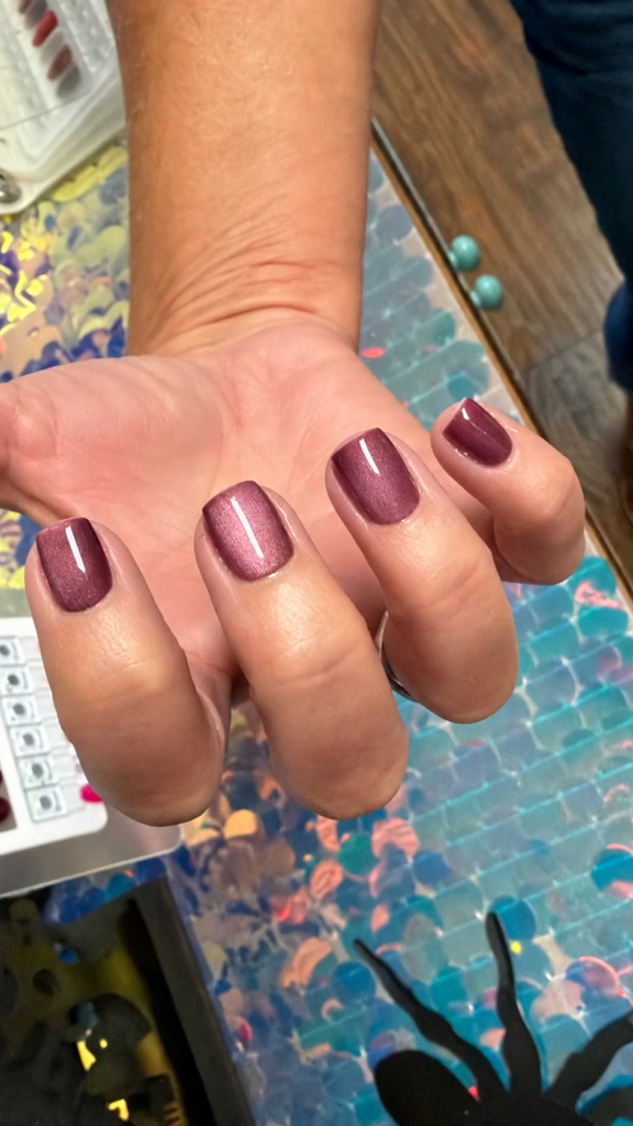 Client wearing Mauvelous mauve cat eye gel polish by Nails Done Right