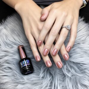 Client manicure featuring Pumpkin Spice Holo copper-orange holographic gel polish